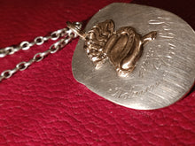 Charger l'image dans la galerie, Reste d'un morceau d'une louche en argent de la société des Vieux grenadiers de Genève, transformée en pendentif.