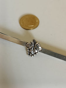 La pince à cravate en argent massif avec des décors de feuilles de vigne et de grappes de raisin
