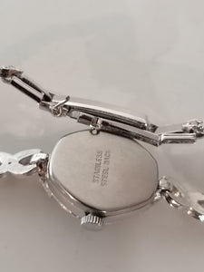 Initial montre bracelet dame rhodié et strass. Mouvement mécanique