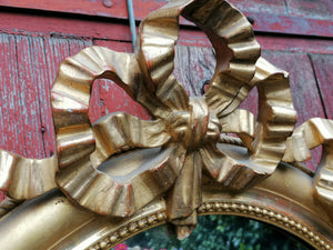 Miroir ovale 19ème doré à la feuille d'or