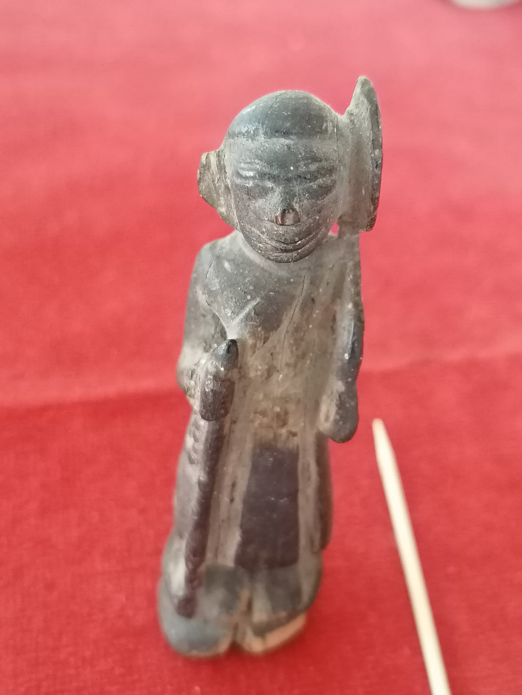 Statuette africaine ancienne en bois sculpté avec sa patine, personnage debout avec object dans les mains. Origine à identifier début XXème 