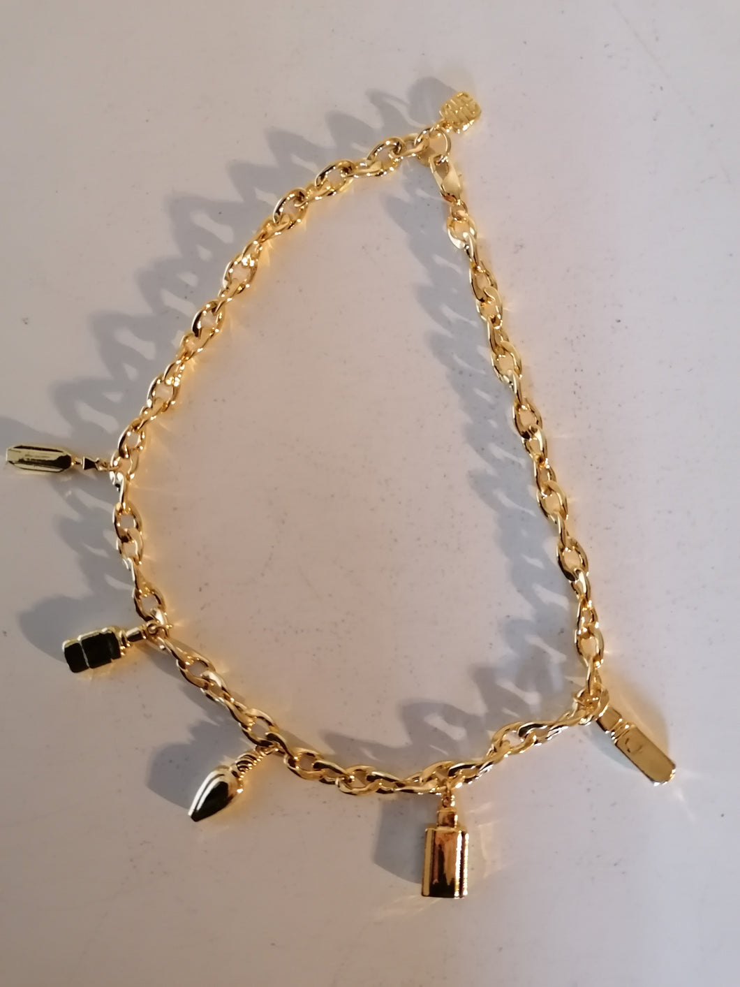 Givenchy Collier doré fantaisie parfait état, motif flacon parfum